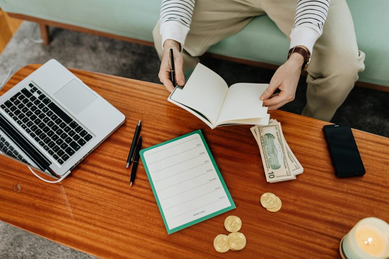 Laptop and notebook used for a weekly money routine in Australia