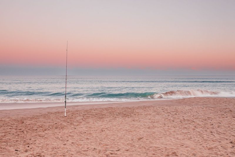 Empty Australian beach at sunset representing free things to do on a tight budget