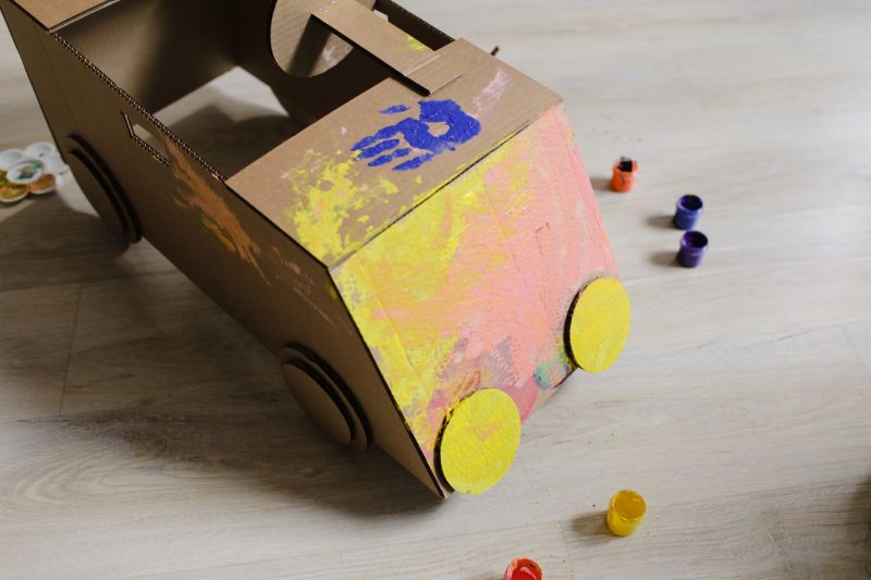 Handmade cardboard toys for a toddler representing saving money on children in the first year