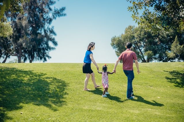 New immigrant family walking together in an Australian park on a low income