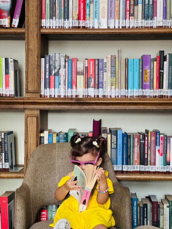Young child reading books at a free public library in Australia