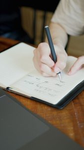 A notebook with handwritten notes and definitions