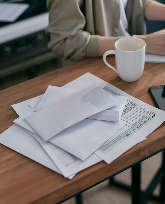 Permanent residency paperwork next to a cup of coffee, symbolising the wait between visa approval and feeling settled