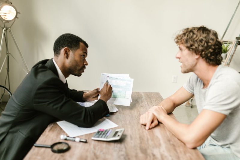 Two people reviewing paperwork together at a desk