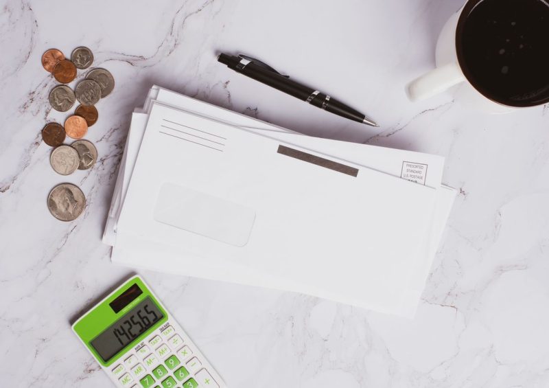Household bills and envelopes on a kitchen table