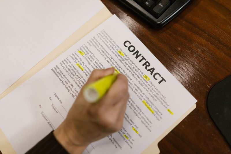 Person reviewing a fixed-term employment contract document