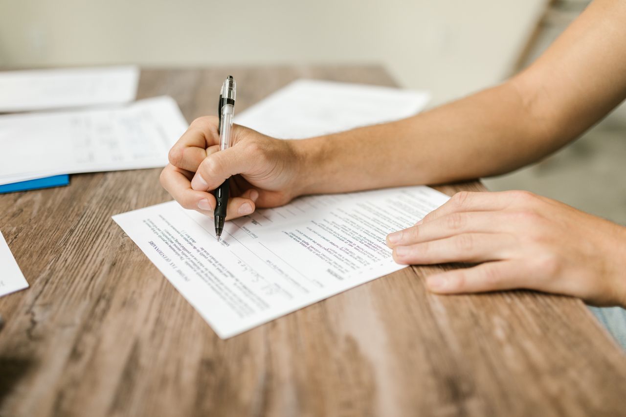 Person filling out a superannuation beneficiary nomination form