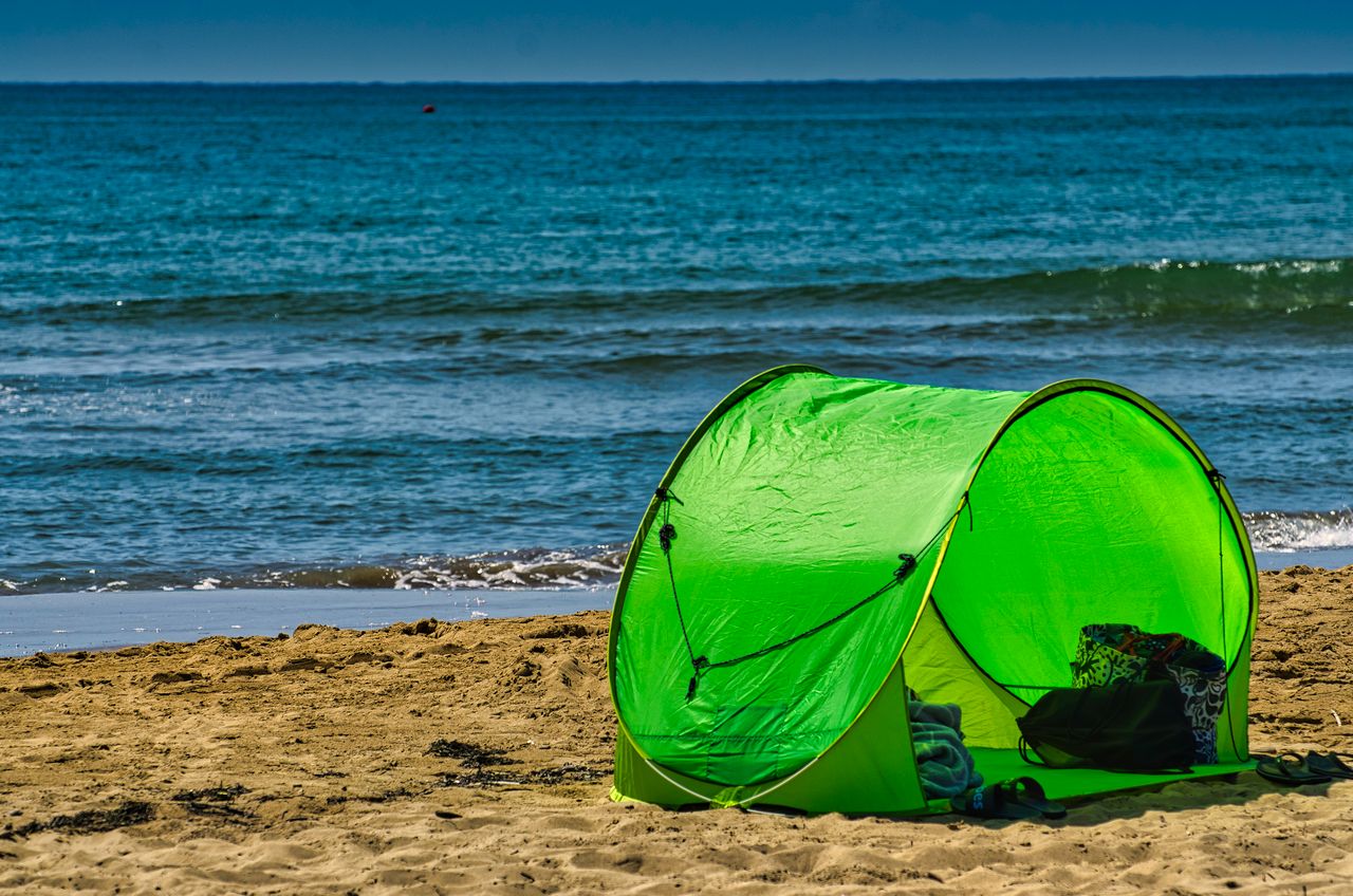 Small beach tent on the sand near the water