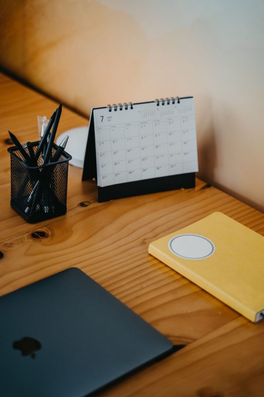 Wall calendar with a pen on a desk
