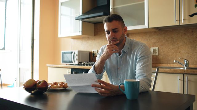 New immigrant reading a government letter about health cover in Australia