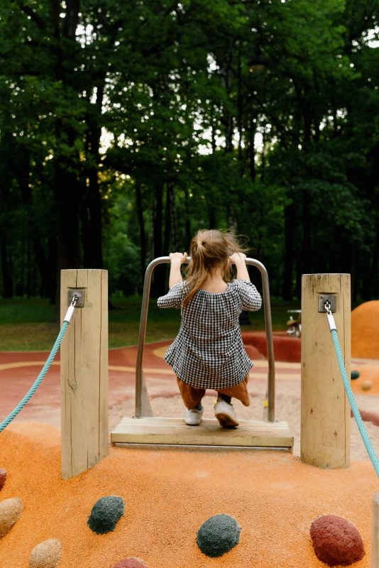 Child playing on a playground slide in an Australian park