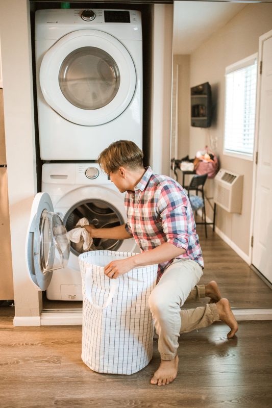 Laundry basket next to a clothes dryer at home