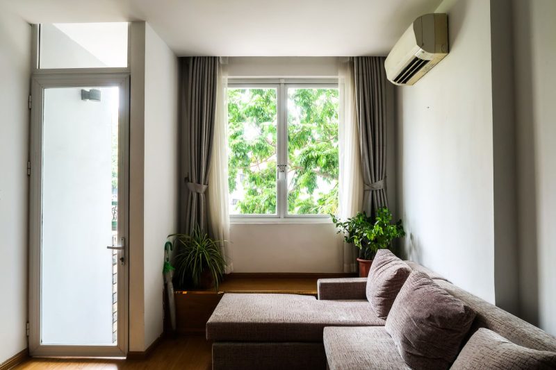Split system air conditioner on a living room wall